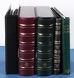 5 · Lighthouse large size 4-ring binders (2) with matching slipcases, SG New Age stamp binder with a few pages, the Royal album loose leaf album, binder & ring binder with about 20 Vario pgs. G-VGC. Replacement cost $400+. (5)